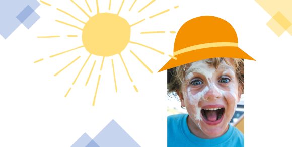 Kind mit Sonnencreme im Gesicht und Sonnenhut